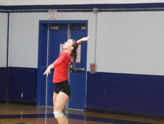 Lady Cards senior Sage Thomas serving the ball to start the point.