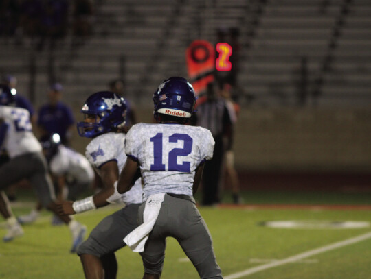 Raiders quarterback Kor ‘Dae Johnson scanning the field for an open receiver to throw the ball to.