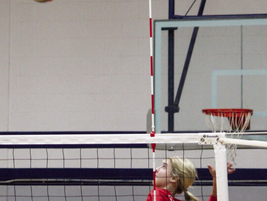 Taylor Morrow jumping in the air before slamming the ball down for a point.