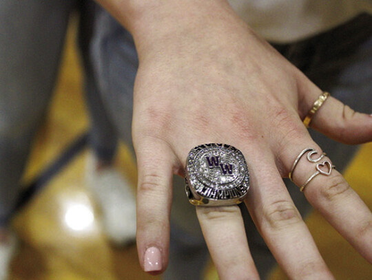 Left: Ladycats showing of their State Championship ring. Right: Natalie Ohnheiser (far left), Kylie Ohnheiser, Brooke Ohnheiser, Rylee Noska and Alazay Moreno reacting to seeing their rings for the first time. Photos by Evan Hale