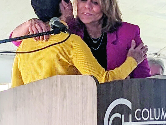 Senators Donna Campbell and Joan Huffman share an embrace before Huffman takes the podium.