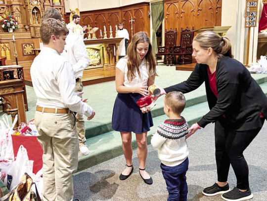 St. Michael students brought canned goods for those in need during Friday Mass.