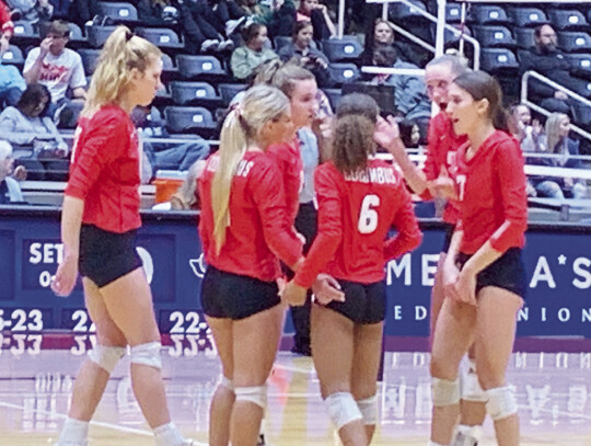 The Lady Cards huddling up to discuss strategy before the fifth set.