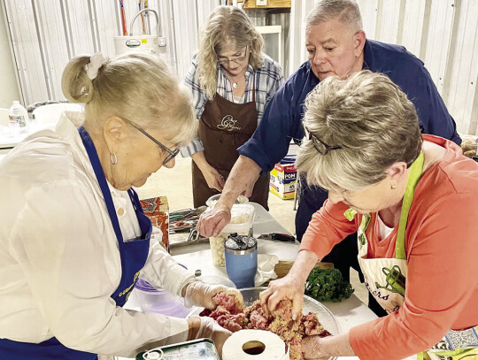 Robin Robinson, Kathleen Townzen and Ann Butler help local caterer Chef Raoul as he prepares to present a cooking class to the Girl Friends Group at the Columbus Boys and Girls Club. Not pictured, but also helping the preparation was Barbara Peterman.