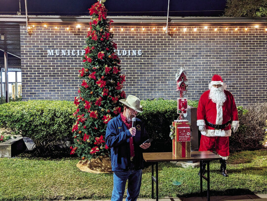 Mayor Tim Kelley addressed the crowd prior to lighting the city Christmas tree with a story of the origins of Christmas trees for the holidays.