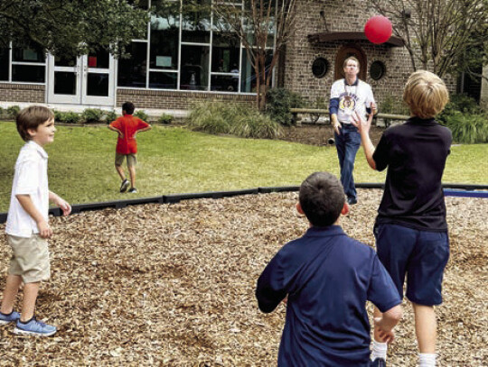 W.A.T.C.H. DOG Robert Parry takes time to play with students at recess. Courtesy photo