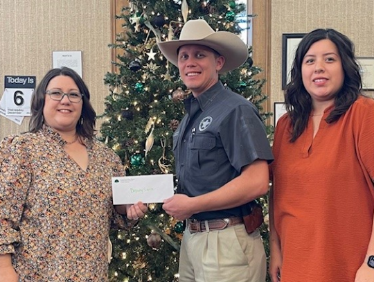 Columbus State Bank collaborated with the Sheriff’s Office and Family and Youth Services to bring joy to the children of families in Colorado County. Columbus State Bank donated funds for the Deputy Santa program. Pictured from left are Sara Everett, Ch