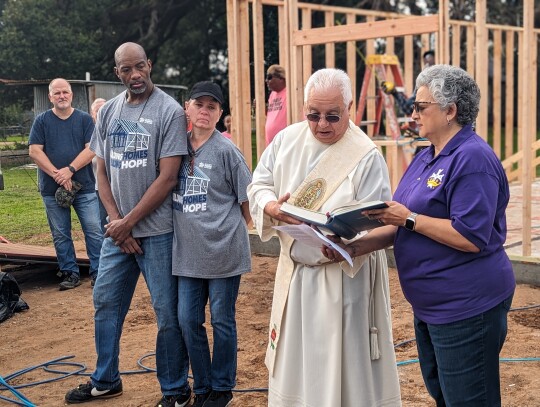 Deacon Ben Munguia blessed the ground for Reggie and Dorothy Evans’ new home along with his wife Maria. Citizen | Trenton Whiting