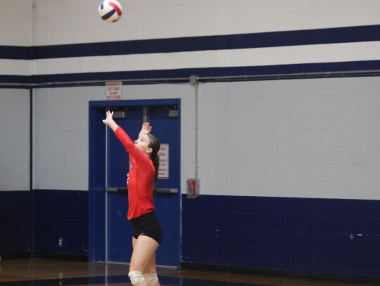 Lady Cards senior setter Sage Thomas serving the ball to start the point.