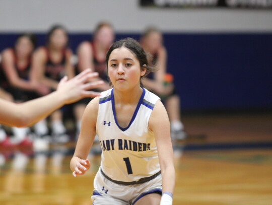 Aleah Conejo carrying the ball up the court before attacking a lane to the basket.