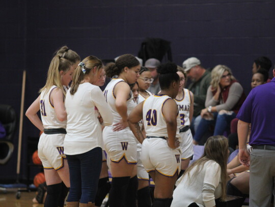 The Ladycats discussing strategy during a timeout.