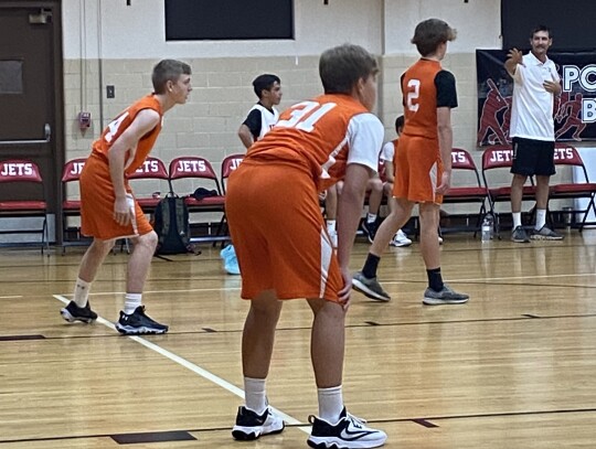 Wyatt Kramr, Tyler Watkins and Hayden Lowe ready their defense against the Nazareth Academy Jets.