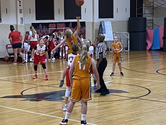 Lady Saints Harper Kramr and Brynn Pilat watch as Emily Fuller competes in a tip off against Nazareth Academy. Courtesy photos