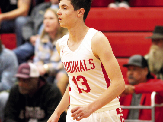 Trevor Berger Running through a lane past a defender to score a layup.