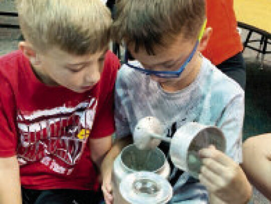 Henry Jones and Seth Ray explore the inner workings of an old coffee pot.