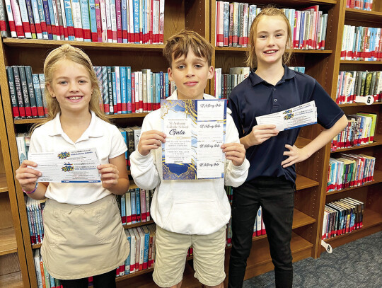 SAS 4th graders Anslee Busselman, Hayes Kridel and Kendal Winkenwerder are ready to sell tickets for the Gala and the Catholic Life raffle.