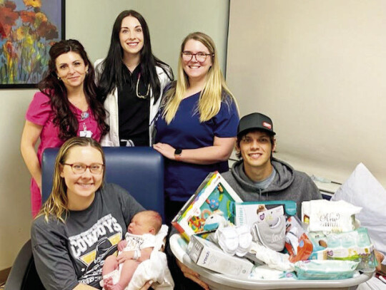 Pictured from left in the front row are Heather Chandler, RN; Kayla Kilefer, P.A.; Meghan Allen, RN. In the second row are the mother Dana Benz and Trey Vavrusa with the father Theo Vavrusa.