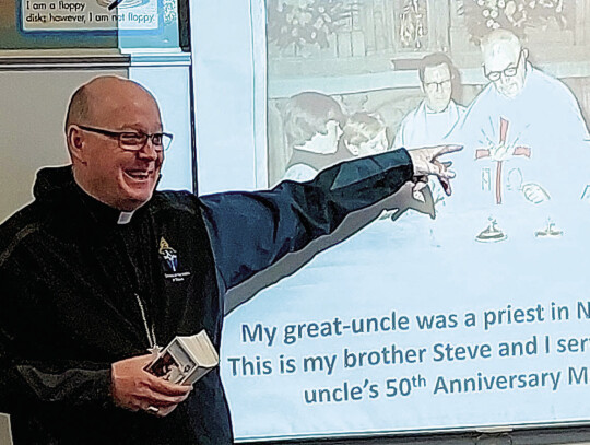 St. Michael was visited by Bishop Brendan Cahill on Friday, Jan. 12. He toured the classrooms, received small gifts from the students and spoke about his life in Priesthood. Here he is visiting the 3rd grade class.