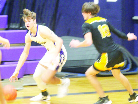 Zachary Norrell running past a defender before kicking the ball out to an open player on the wing.