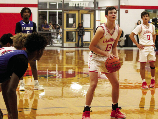 Trevor Berger shooting a free throw to close in on the Raiders lead before overtime.