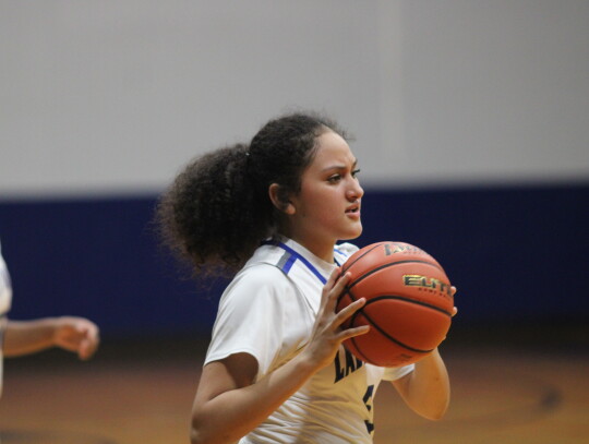 Jayden Moreida checking the ball in leading to a easy layup for the Lady Raiders.