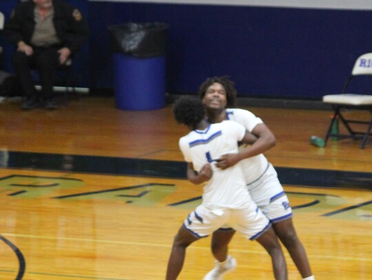 Ta’Marion Turner bear hugging D’Neriyan Fuller after winning the game in overtime.