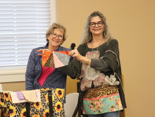 Michelle Lavender holding up Tricia Griste’s Wonky Triangle.