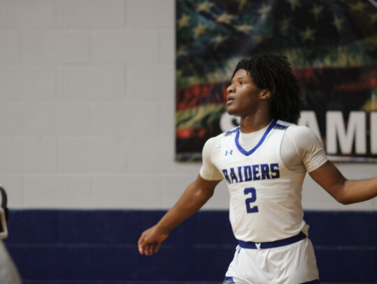 Robert Bennett bringing the ball up the floor looking for an opening in the defense. Citizen | Evan Hale