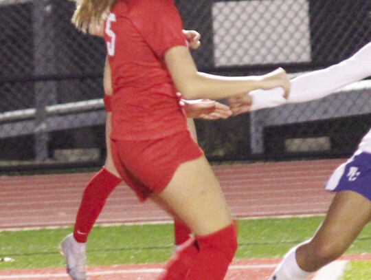 Savannah Daniel fighting for a loose ball in front of the net.