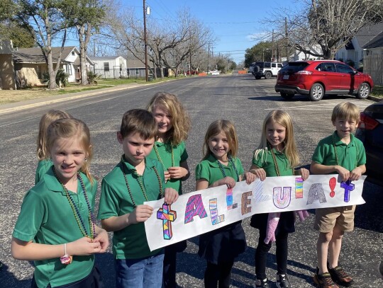 Second grade students with their Alleluia banner.