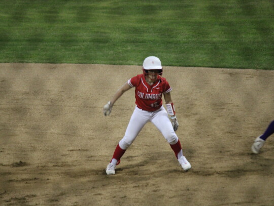 Kaylea Foster considering stealing second base before retreating back to first.