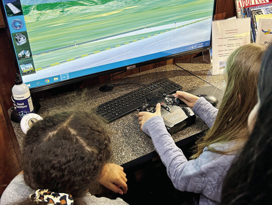 The Girl Friends got to fly a plane through a simulator.