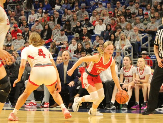 Karlee Mathis crossing over a defender and driving the open lane for an easy layup.