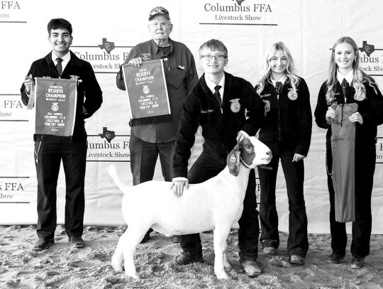 MARKET GOAT Samuel Ricicar; Bought by Tonkawa Farms/Hildebrand Family for $2,849. Pictured with Javier Mendoza, a representative from Tonkawa Farms, Ezra Ricicar and Alley Fitzgerald.