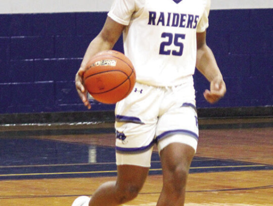 Robert Bennett carrying the ball up the floor for the Raiders.