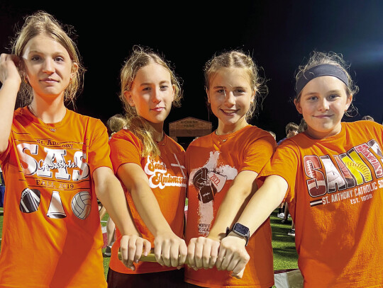 8th graders Logan Glueck, Claire McBride, Emma Beauchamp and Charly Spanihel celebrate a 2nd place win in the 400m relay at the St. Philip track meet.