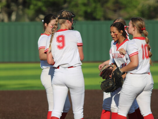 Mia Post celebrating a strikeout with her teammates.