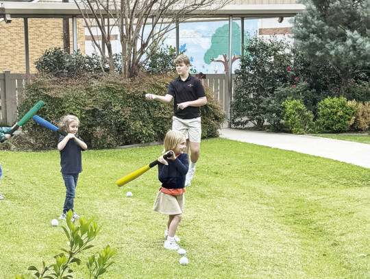 Nice Spring weather allowed the 8th graders to spend time with PreK classes during their PE time. Tyler Watkins and Deacon Barten work on batting skills with the youngsters. 