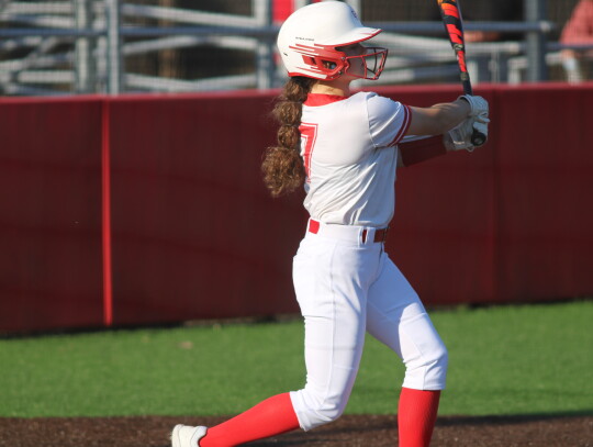 Allie Cranek swinging and recording an RBI after being thrown out at first.