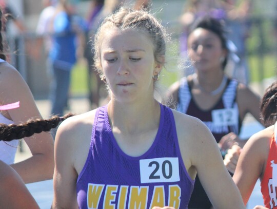 Tate Griffin staying in the pack before breaking free late in the 3200m.