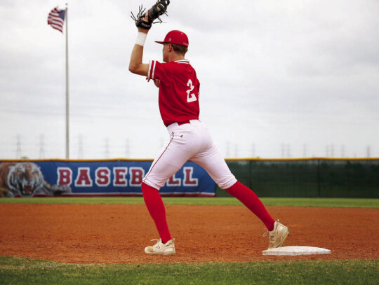 Brody Tribe catching a ball thrown to him to secure an out for the Cards at first base.